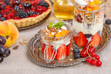 Layer fruit dessert in glass container. Summer party.