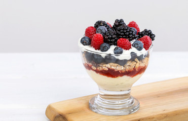 Layer fruit dessert in glass container. Summer party.
