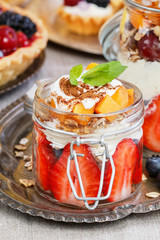 Layer fruit dessert in glass container. Summer party.