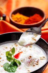 Creamy white soup decorated with herbs.