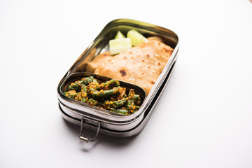 Lunch Box / Tiffin for Indian kids, includes beans vegetable sabzi with roti or chapati, selective focus