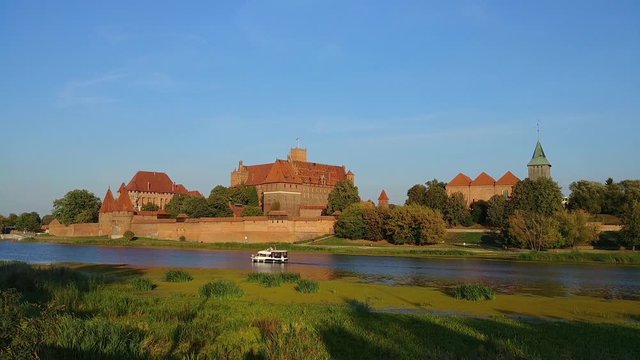 Malbork Castle. Old Historical Teutonic fortress landmark on Nogat river at summer day in Poland Europe
