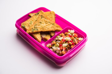 Lunch Box / Tiffin for Indian kids, includes bread Omelette pakora with tomato ketchup or sprouts, selective focus