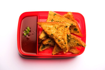 Lunch Box / Tiffin for Indian kids, includes bread Omelette pakora with tomato ketchup or sprouts, selective focus