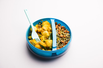 Lunch Box / Tiffin for Indian kids, includes vegetable bread Upma with sprouts, selective focus