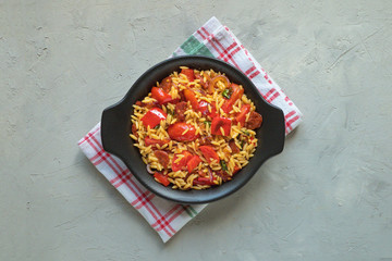 Roasted pepper and chorizo orzo salad combines red peppers, red onion, chorizo and cherry tomatoes with orzo pasta. 