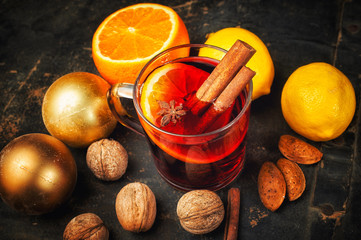 Christmas drink mulled wine, fruit and spices on a wooden table
