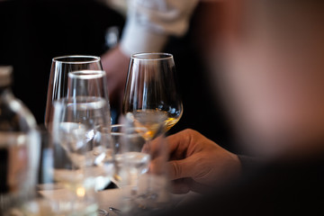 Glass of white, rose and red wine seen from close up.