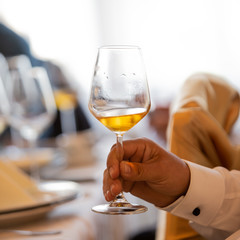 Glass of white, rose and red wine seen from close up.