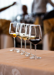 Glass of white, rose and red wine seen from close up.