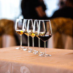 Glass of white, rose and red wine seen from close up.