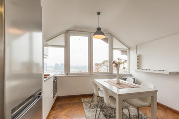 Fototapeta na wymiar Kitchen interior with dining area in loft apartment