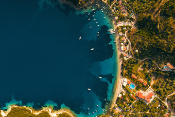 Aerial view from the drone to the panorama of the blue sea and the picturesque islands in Greece, in summer on a sunny day. Beautiful coastline of the resort town. Tourism. Family travel