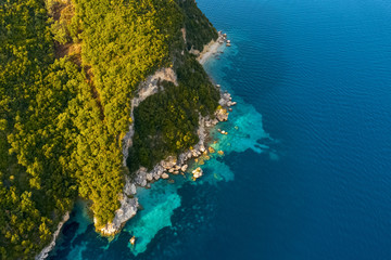 Aerial view drone panorama of the blue sea, picturesque islands and mountains in Greece, in summer on a sunny day. Beautiful coastline of the resort town. Tourism. Travel