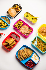 group of Lunch Box / Tiffin for Indian kids, showing variety or multiple option or combination of healthy food for your school going children
