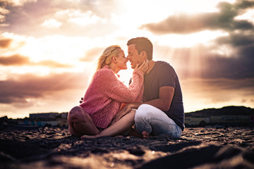 Romantic scenic moment and love concept with couple of young beautiful people hugging and kissing...