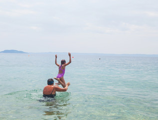 Child jumping in the sea