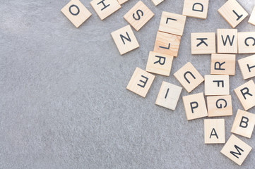 Alphabet letters on a grey background.