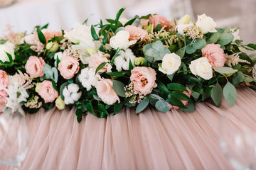 Elegant decoration of groom and bride 's wedding table with fatin and fresh flowers with white cotton.