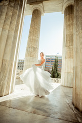 Vintage portrait of dancing bride against classic columns