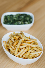 Hamburger and french fries. Tasty french fries on cutting board, on wooden table background. Hamburger and fried potatoes on a wooden table