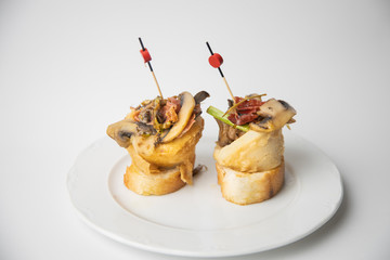 typical spanish tapa se bacon and squid mushrooms