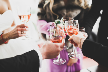 Bride and a groom with the glasses of champagne