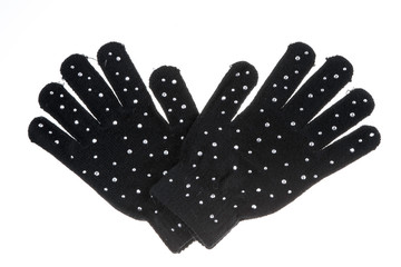 Warm woolen knitted black gloves with crystal stones,close up and isolated on white background