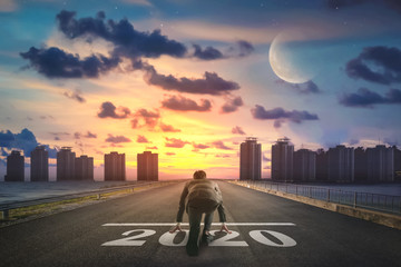 Businessman starting road to success 2020. Elements of this image furnished by NASA.