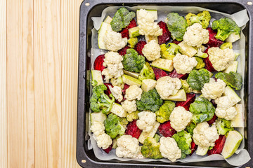 Assorted fresh vegetables on a baking tray. Cauliflower, broccoli, beets, zucchini