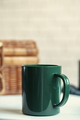 Green plastic kitchenware on a table close up