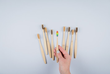 Flat lay composition with bamboo toothbrushes on grey background. Eco natural bamboo toothbrushes. Zero waste, plastic free items concept. Top view, copy space