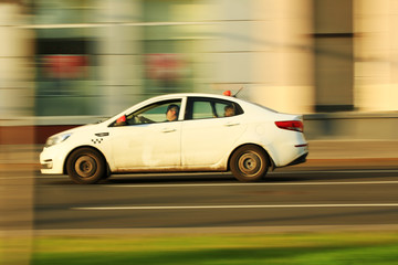 Fototapeta na wymiar dirty taxi car in motion around the city. blur