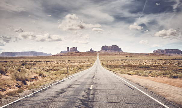 Retro stylized picture of Monument Valley seen from famous U.S. Route 163, Utah, USA.