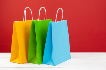 Arrangement of shopping bags on red background