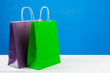 Paper shopping bags with copy space on blue background