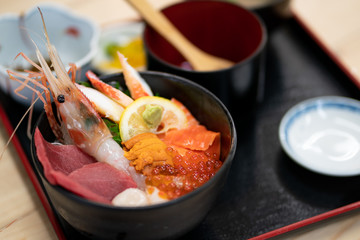 Kaisen Don (Sashimi seafood Rice Bowl) served in a black Bowl, Japanese food.
