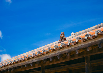 Fototapeta na wymiar Okinawa Lion on Ryukyu architecture Roof Art Blue sky background Okinawa island Japan