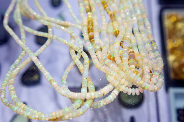 Faceted high quality natural opal beads on the shop window glass