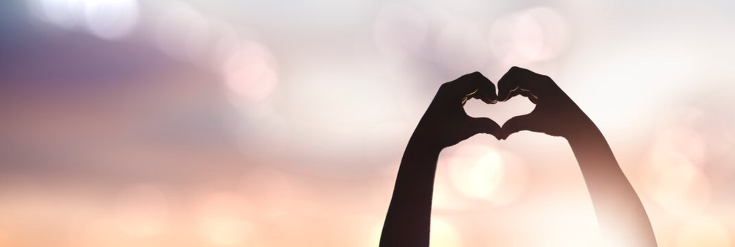female hands silhouette in a heart shape