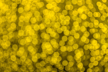 Abstract beautiful blurred gold yellow colored bokeh from ornamental lights flickering in the park....