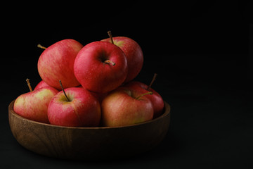 ripe red apples in wooden bowl