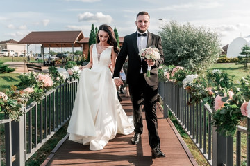 bride and groom walking on a narrow bridge. holidays and traditions