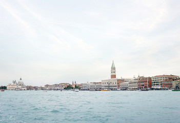 Fototapeta na wymiar View of the Venice promenade and the Campanile of St. Mark Cathedral and the Doges Palace from the side of the Venetian lagoon