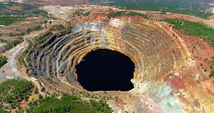 Old open pit mine of Rio Tinto in Spain with rock or ore mining. This is the production industry - industry and landscape concept