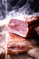 Freshly smoked bacon strips. Home made, tasty cold cuts.