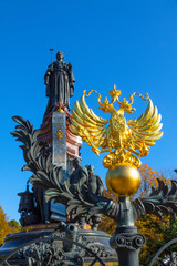 Fototapeta na wymiar Russia, Krasnodar, monument to Catherine II, Golden coat of arms of Russia double-headed eagle, 2018