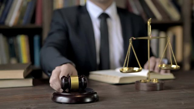Close up Shoot of Judge Hand Bang the Gavel while Reading Book