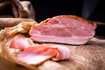 A piece of freshly smoked bacon. Home made, tasty cold cuts.