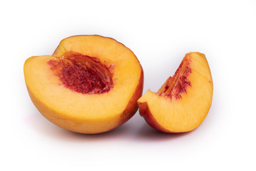 Naklejka na ściany i meble Side view of freshly cutted in a half colorful peach with one extra slice